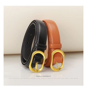 Detail of minimalist black and caramel leather belts with matte gold oval buckles