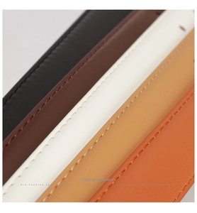 Detailed close-up of colorful leather belts in black, brown, white, tan, and orange hues