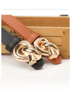 Close-up of alloy knot buckles on textured black and caramel leather belts