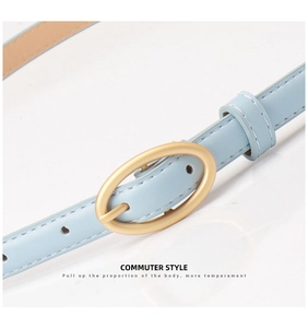 Detail of light blue leather belt featuring a matte gold oval buckle in commuter style