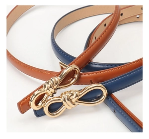 Detail of slim leather belts with elegant golden twist buckles in brown and navy blue colors