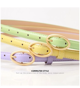 Three pastel faux leather skinny belts in green, yellow, and purple with oval gold buckles