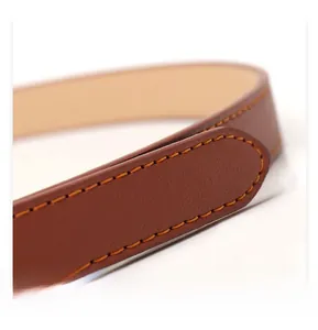 Close-up of brown leather belt with high-quality orange stitching and fine texture