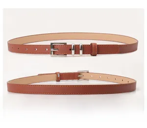 Close-up of brown faux leather belt featuring a silver square buckle and fine stitching