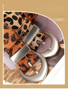 Close-up of leopard print PU leather belts with matte silver horseshoe buckles