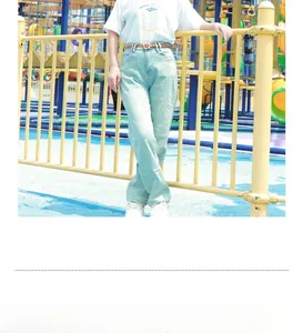 Detail of slim brown leather belt with golden square buckle and model styling view