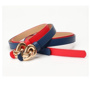 Close-up of slim leather belts in red and dark blue with golden linked metal buckles