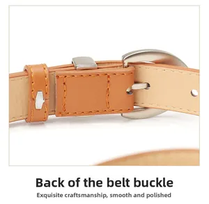 Detailed macro view of the silver metal pin buckle and stitching on the brown PU belt