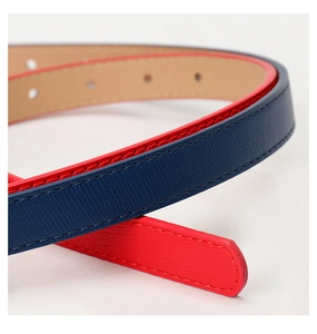 Detail view of contrast color leather belt with cross pattern texture and neat stitching
