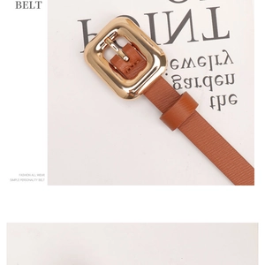 Close-up of brown litchi pattern leather belt with a polished gold pin buckle