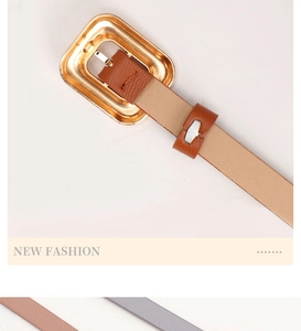 Detailed macro view of an elegant brown leather belt with a vintage gold metal buckle