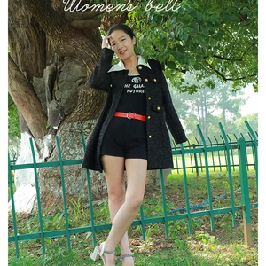 Fashionable red leather belt for women with elegant round metal buckle on black jacket