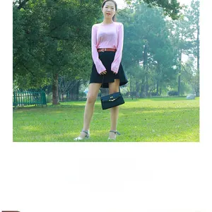 Fashionable brown faux leather belt shown on a model with pink top and black skirt outfit