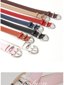 Row of colorful thin women's belts in eight shades with elegant silver oval buckles