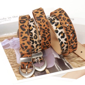 Stylish leopard print PU leather belt with silver heart-shaped buckle on a magazine