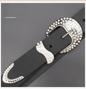 Detail of western black leather belt featuring sparkling rhinestones and silver metal buckles