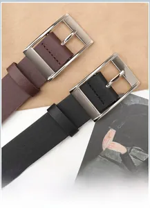 Detailed macro view of black and brown PU leather belts with silver alloy square buckles
