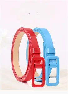 Detail of red and sky blue shiny patent leather skinny belts with matching square buckles