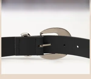 Detail of black leather belt featuring a durable silver alloy horseshoe buckle mechanism