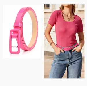 Detail view of pink skinny waist belt with matching buckle on blue jeans for women