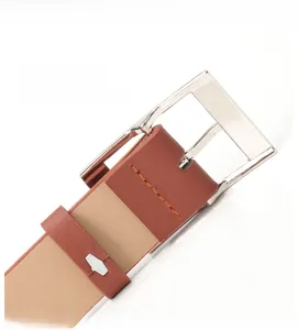Detailed close-up of a silver square alloy buckle and brown litchi pattern leather belt