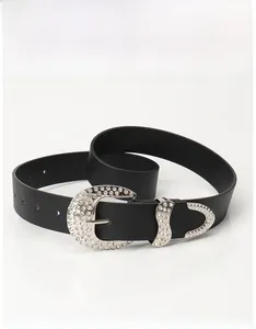 Detailed view of black rhinestone belt with a crescent buckle and decorative silver metal tip