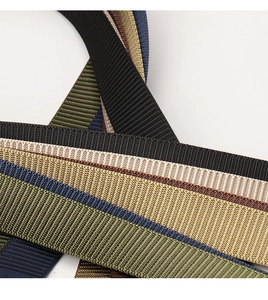 Close-up of thick nylon webbing belts in multiple colors with reinforced weave pattern