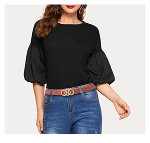Brown leather belt with golden double ring buckle worn on blue denim jeans