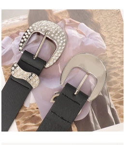 Detail of western style black leather belts with rhinestone and polished silver buckles