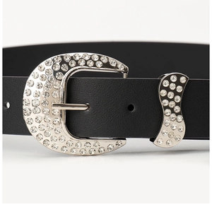 Detail shot of black leather belt with silver moon buckle and sparkling rhinestones