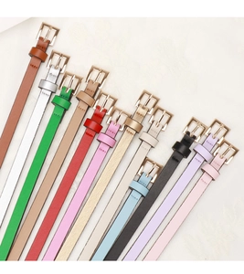 Detailed flat lay of slim PU leather belts for women showing 12 vibrant colors and metal buckles