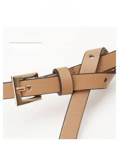 Detailed close-up of tan PU leather skinny belt with golden square buckle and texture