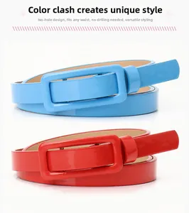 Detail view of hole-free patent leather thin belts in blue and red with rectangular buckle
