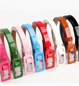 Macro shot of colorful glossy patent leather belts with matching square buckles for women