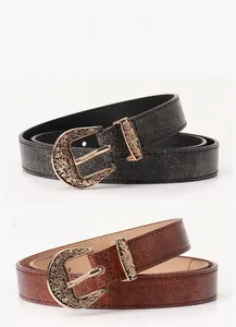 Detailed view of vintage metal buckles with floral engraving on black and coffee belts