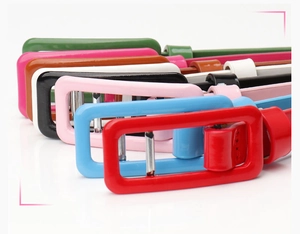 Detail showing glossy patent leather skinny belts with colorful matching buckles