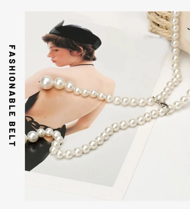 Detail view of a multilayer pearl chain belt for dresses with a silver metal hook clasp