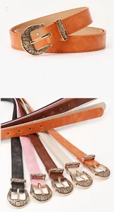 Macro detail of vintage engraved metal buckle and colorful leather belts for dresses