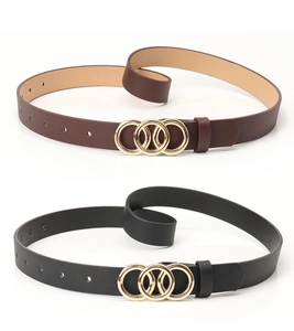 Detail of fashion belts in black and brown featuring elegant gold triple ring buckles
