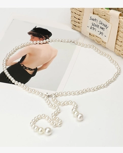 Detailed close-up of fashion faux pearl waist chain with large pendant drops and metal clasp
