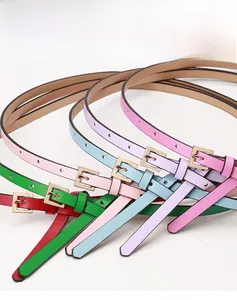 Detail view of colorful slim PU leather belts with gold buckles and multiple adjustment holes