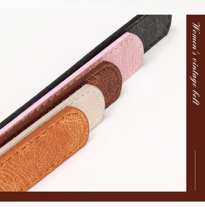 Close-up of five colorful vintage women's belts with elegant stitching and leather texture