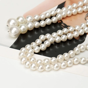 Elegant layered pearl waist chain featuring dual strands and oversized pearl pendants