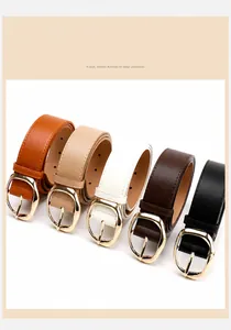 Close-up of five stylish PU leather belts with gold oval buckles in various colors