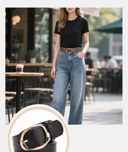 Close-up of a stylish oval gold buckle on a black PU leather belt worn with denim jeans