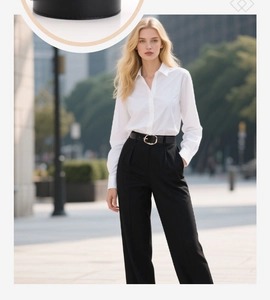 Detail view of women's black PU belt with a polished gold oval buckle on casual jeans