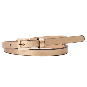 Slim champagne gold women's PU leather belt with polished metal square buckle on white background