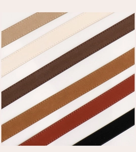 Détail de ceintures en daim vintage montrant les coutures soignées et diverses couleurs