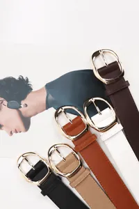 Detail of five PU leather belts with gold buckles on vintage magazine pages