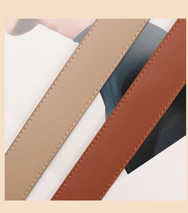Close-up of khaki and brown PU leather belts featuring fine lychee grain and double stitching